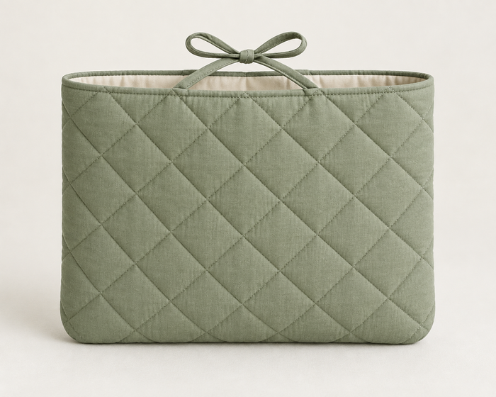 AI design preview: sage quilted book sleeve with rounded lower corners and a top-center fabric bow