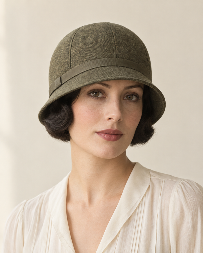 Front design preview of a 1920s sewn cloche hat in olive wool with shaped crown panels and a short brim.
