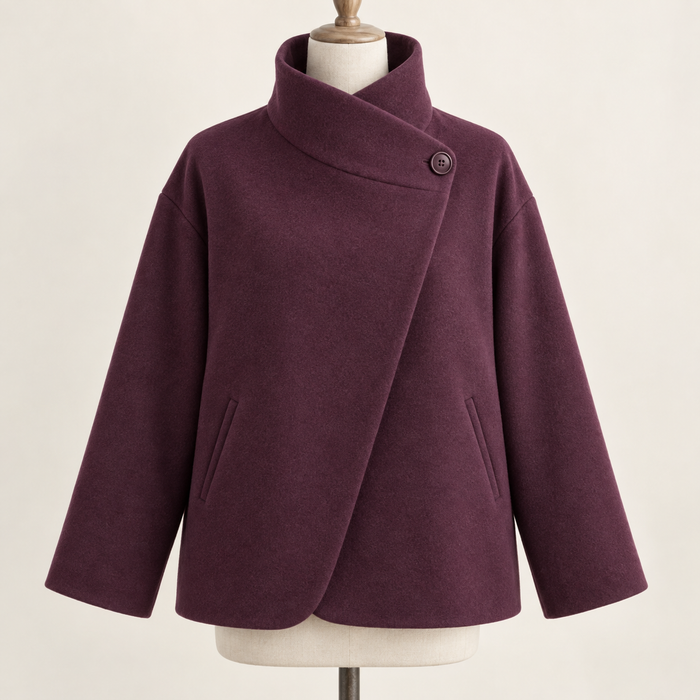 AI design preview: plum asymmetric funnel-neck jacket front with one high side button, diagonal overlap, dropped shoulders and two slanted welt pockets
