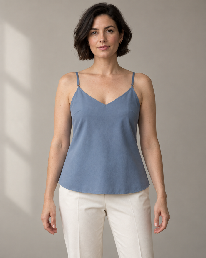 Front design preview of a blue woven camisole with narrow adjustable straps and a V neckline.
