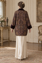 Back view of the plum and gold SL004 evening coat design, showing the relaxed silhouette, centre-back seam and velvet cuffs.