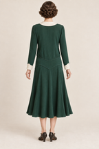AI design concept: emerald chevron-yoke dress showing the pointed back yoke and long cuffed sleeves.