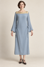 AI design concept: powder-blue 1920s hip-tie dress with antique-gold yoke and long sleeves, front.
