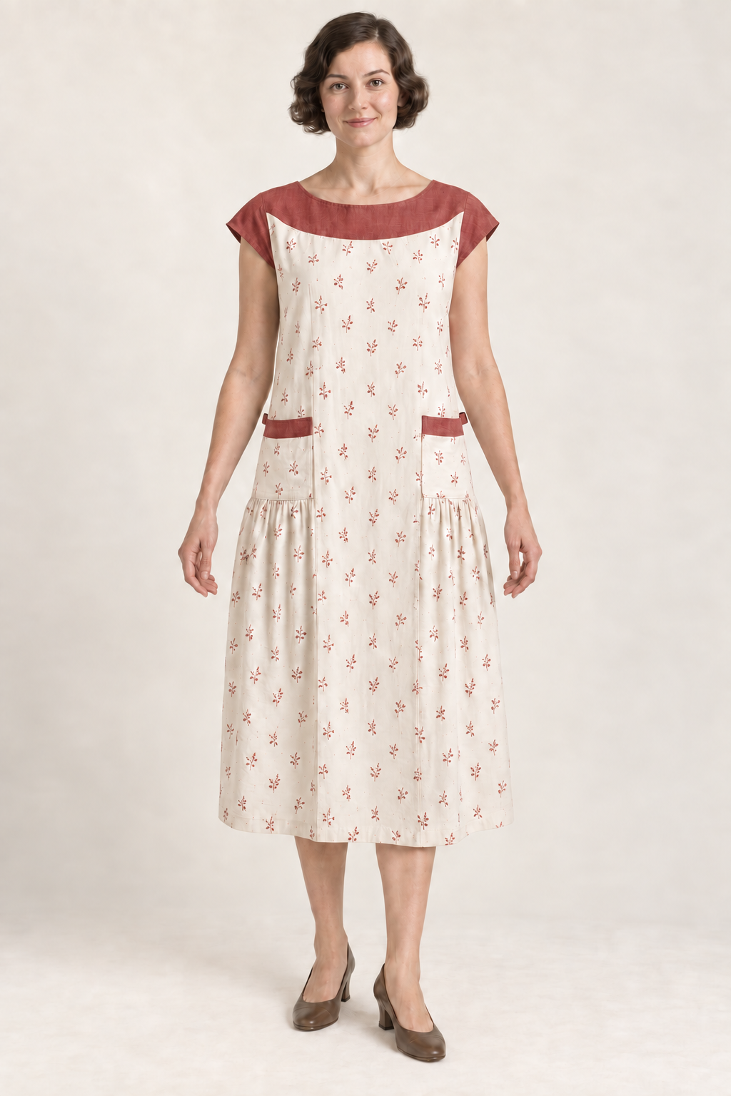 AI design illustration of the same yoke apron dress in ivory with muted brick-red sprigs and contrast yoke, front view