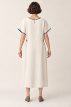 AI design illustration of the cream and indigo bungalow dress from behind, showing its closed back and small neck opening