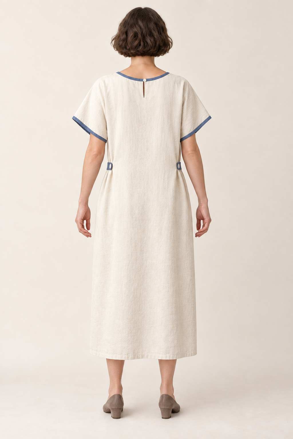AI design illustration of the cream and indigo bungalow dress from behind, showing its closed back and small neck opening