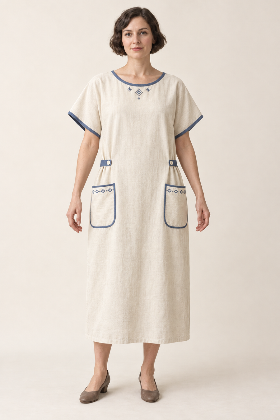 AI design illustration of a cream 1923 bungalow apron dress with indigo edging, kimono sleeves, buttoned side tabs and rounded pockets, front view