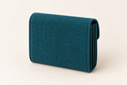 AI design preview: closed petrol teal accordion wallet from the plain rear with compressed side folds