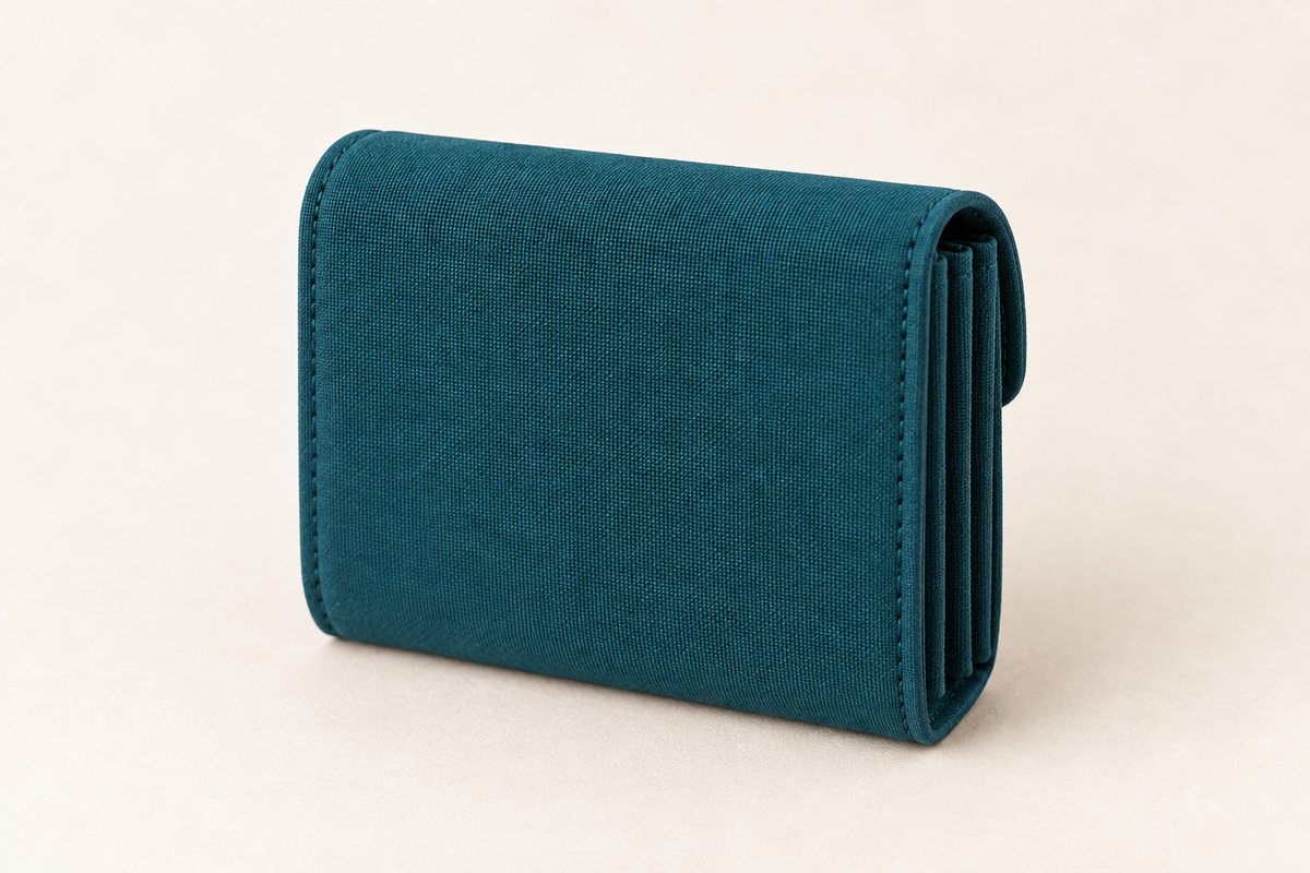 AI design preview: closed petrol teal accordion wallet from the plain rear with compressed side folds