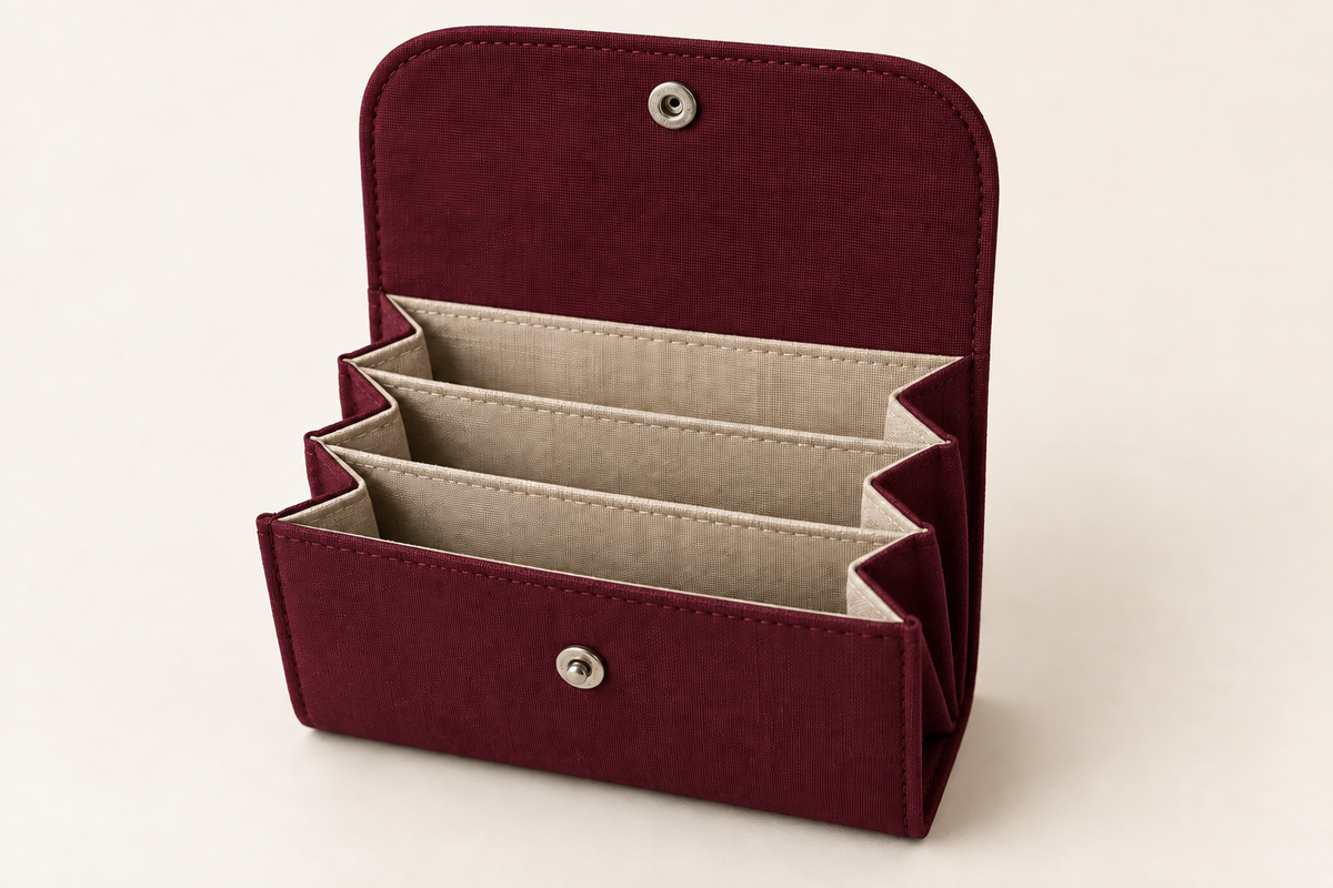 AI design preview: burgundy color of the same open three-compartment accordion wallet with rounded snap flap