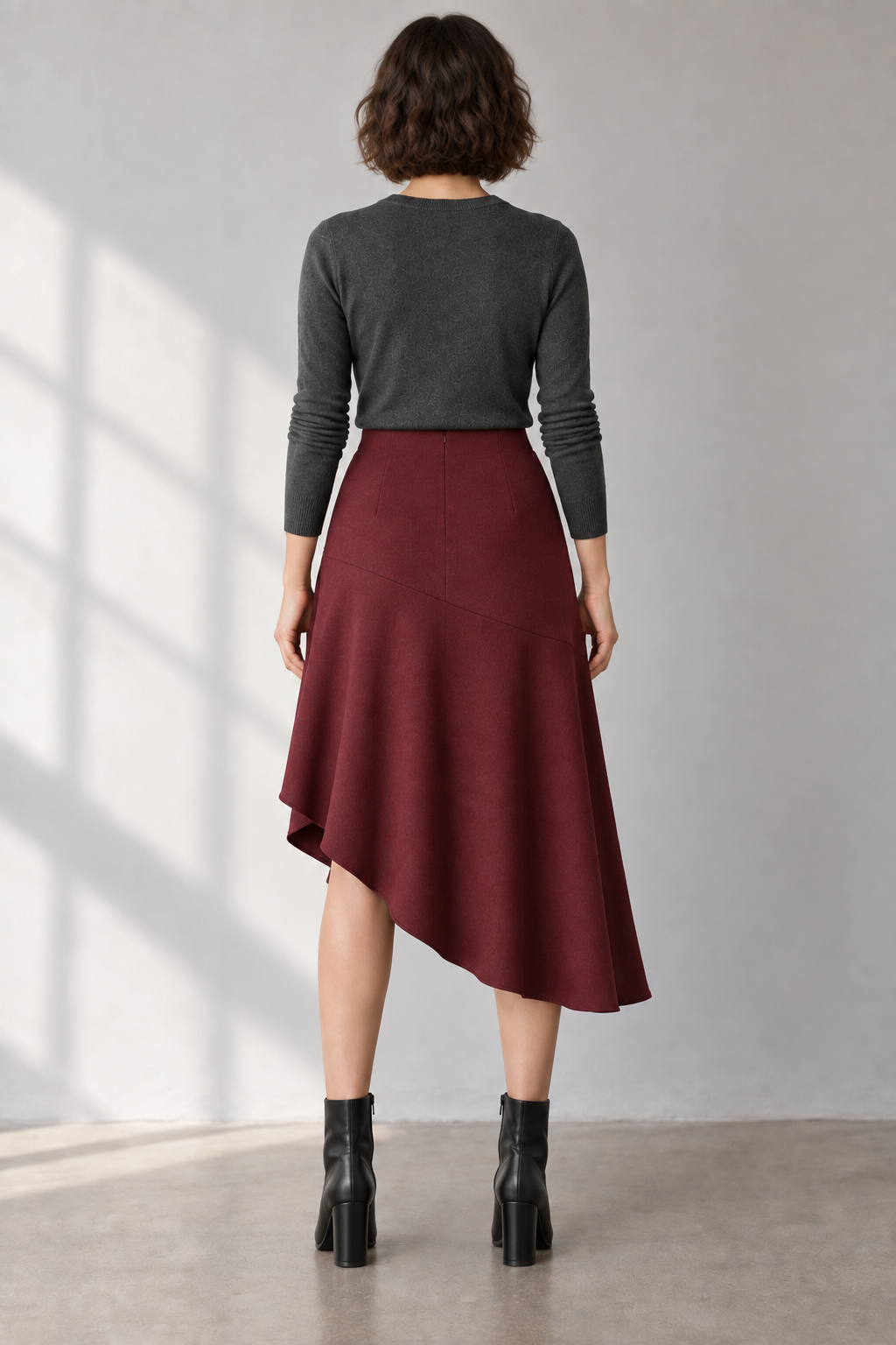 Rear design preview of the same oxblood midi skirt, with a smooth faced waist and closed mid-calf back