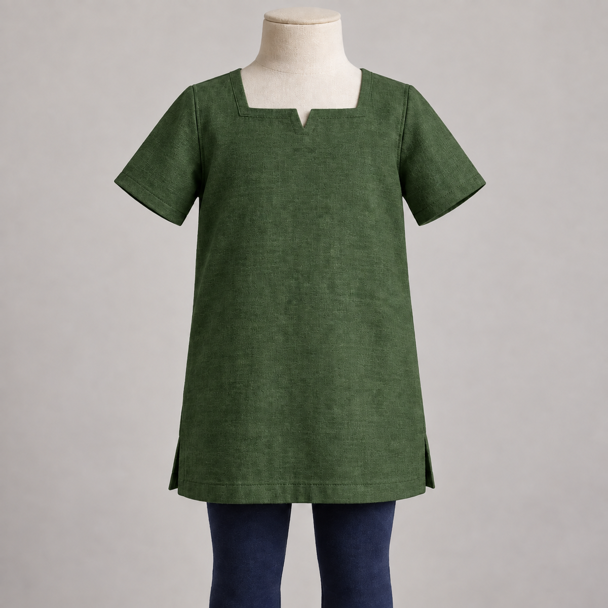 AI design preview: muted forest green color of the same child-specific square-notch tunic with no neck cords or fasteners