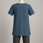 AI design preview: rear of petrol-blue square-keyhole tunic showing a plain closed back, shallow faced neck and short set-in sleeves