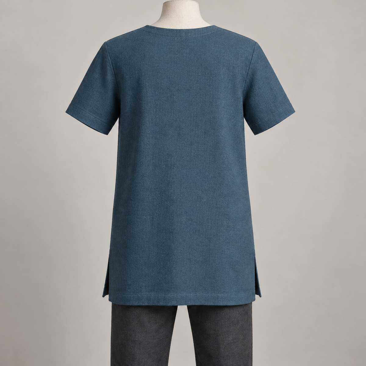 AI design preview: rear of petrol-blue square-keyhole tunic showing a plain closed back, shallow faced neck and short set-in sleeves