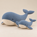 Large and small blue whale plush versions together, each with ivory belly and embroidered details