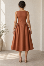AI design preview: copper side-gathered midi dress on an adult woman, closed boat-neck back and concealed center-back zipper.