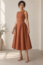 AI design preview: three-quarter view of an adult woman wearing the copper boat-neck dress, showing shaped waist and side gathers.