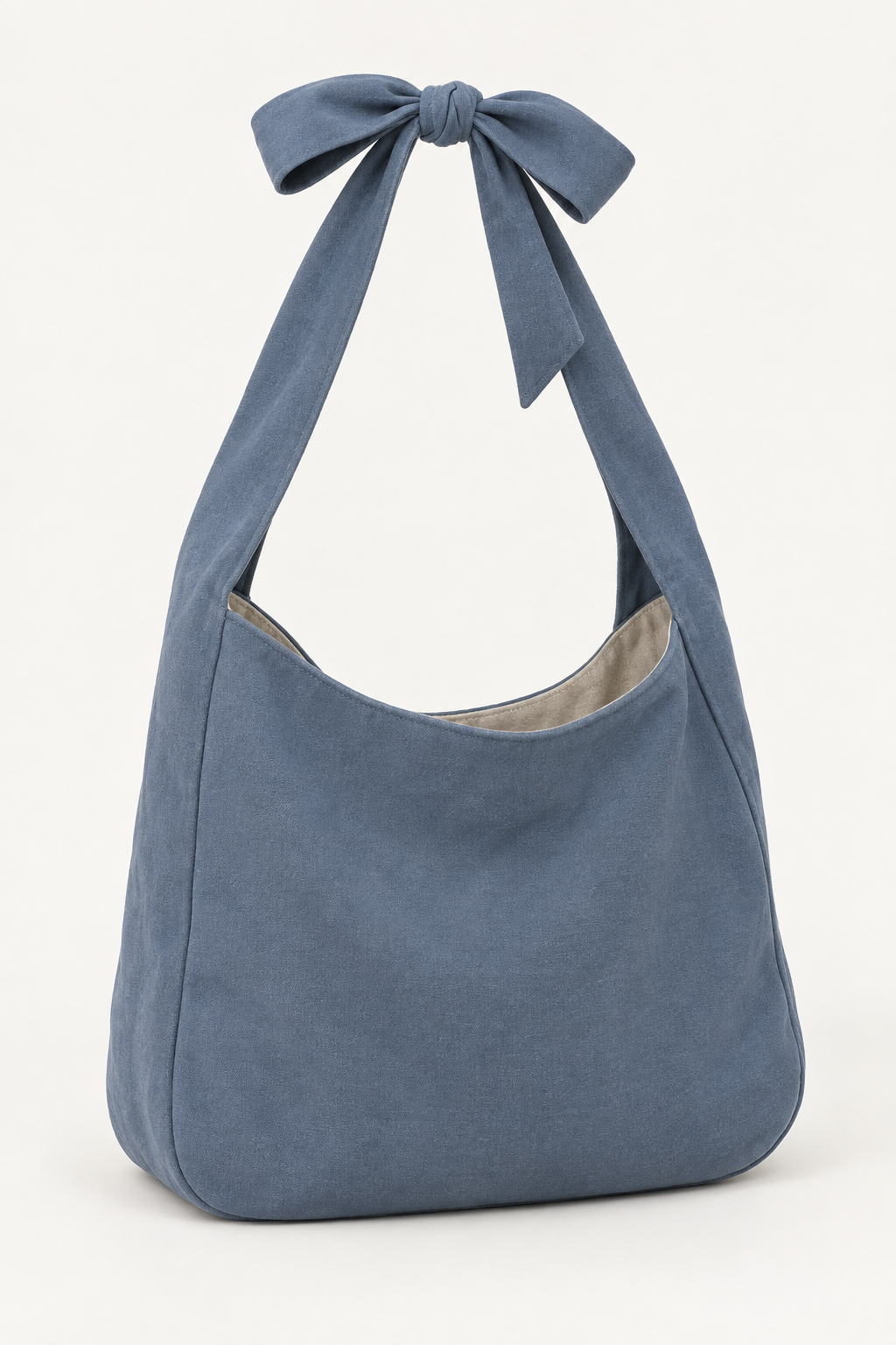 AI design preview: slate-blue shoulder bag with a functional bow joining the broad fabric strap ends
