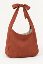AI design preview: terracotta shoulder bag with the same bow-joined loop and plain lined body