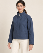 AI design preview: three-quarter view of the blue unlined jacket design showing tall collar, covered center opening and welt pocket