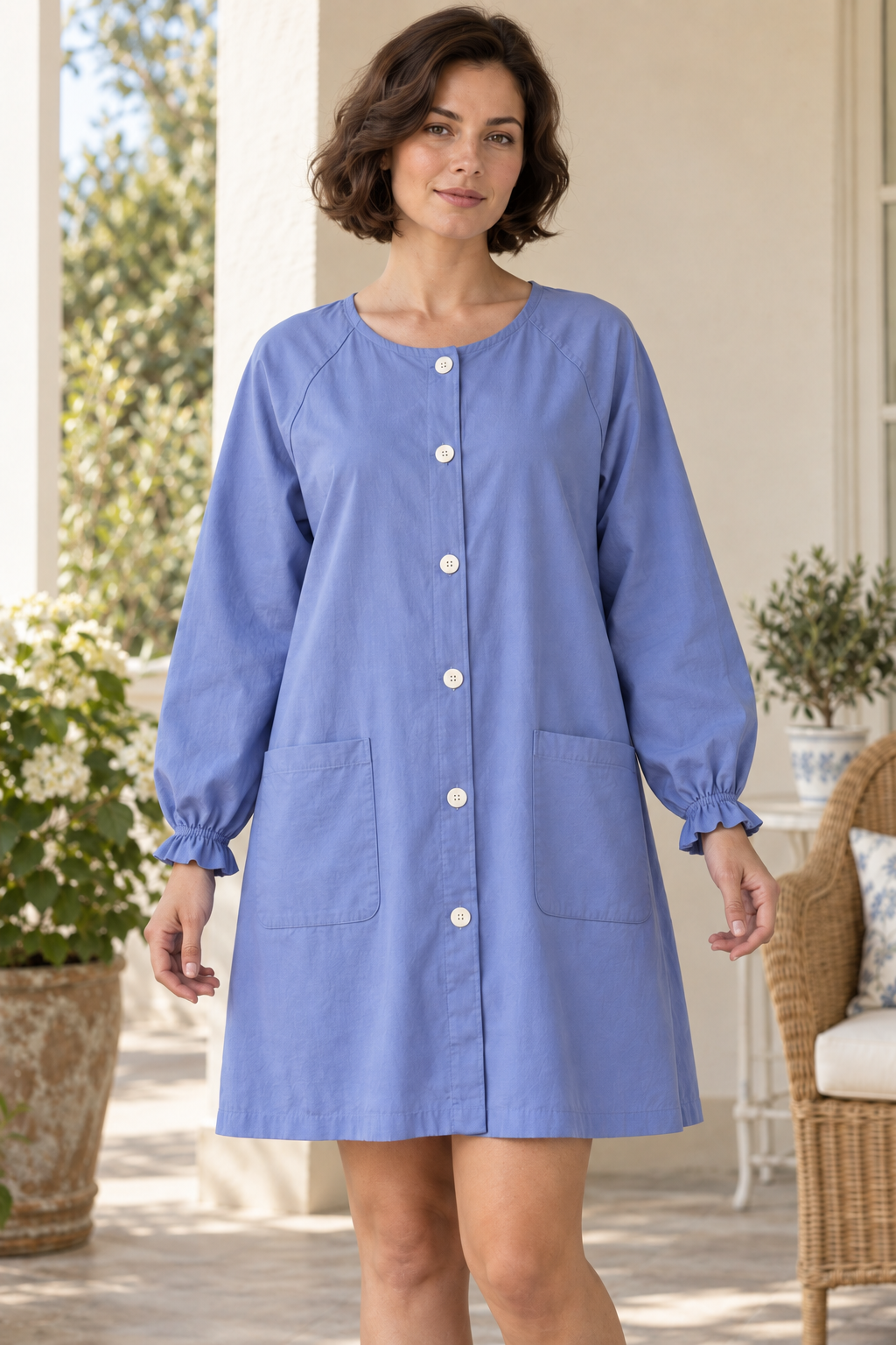 Close front design preview showing six ivory buttons, round neckline, patch pockets and self-ruffled wrists