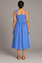 Back design preview of the cornflower blue sundress with straight fixed straps, a plain darted bodice and gathered midi skirt.