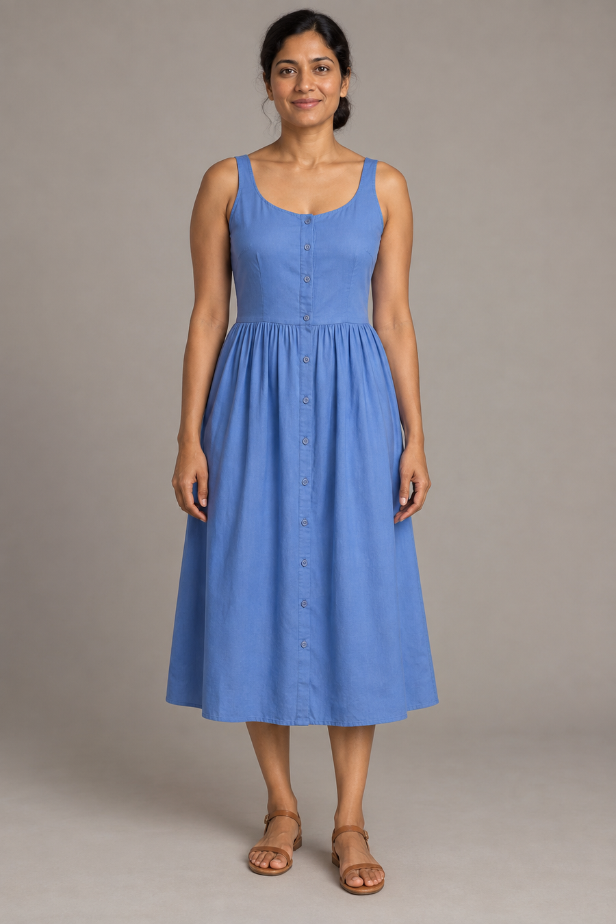 Front design preview of a cornflower blue button-front sundress with fixed straps, a scoop neckline and gathered midi skirt.