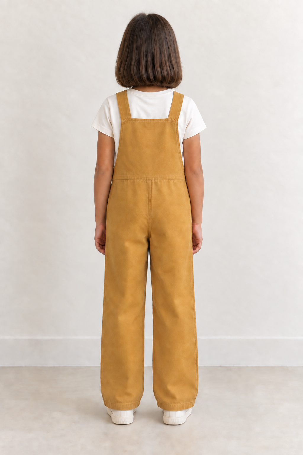 AI design preview: same child and ochre overalls showing plain rear bib, parallel straps, single waist join and straight legs, rear view
