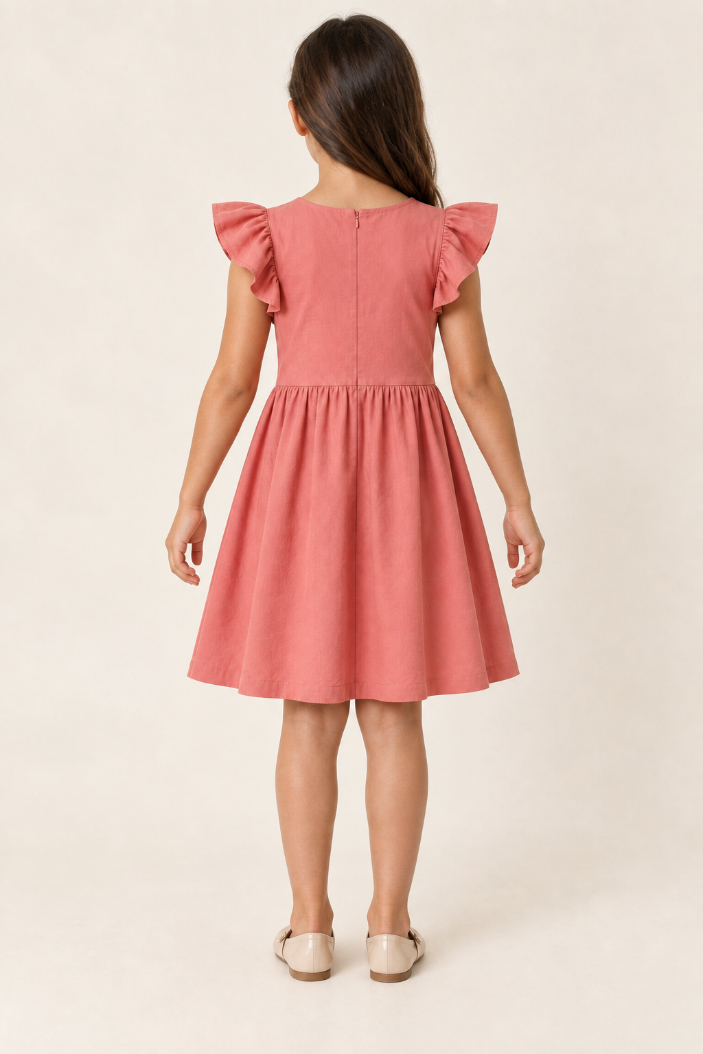 AI design preview: rear of the same coral children’s dress showing a closed round neckline, concealed back zipper and flutter sleeves
