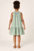 AI design preview: rear of the same sage children’s dress showing gathered neckband, short buttoned slit and single lower flounce