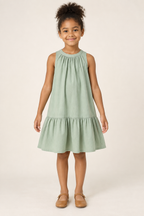 AI design preview: child in a sage-green sleeveless dress with gathers into a round neckband and one lower flounce