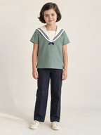 Child wearing a sea-green short-sleeve sailor middy blouse with ivory collar and opaque inset
