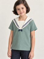 Front collar detail of children's sailor blouse with navy double braid and short fixed knot tabs