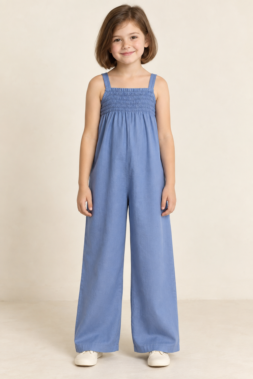 AI design preview: child in cornflower-blue jumpsuit with narrow shirred upper chest, fixed straps and loose wide full-length legs, front view