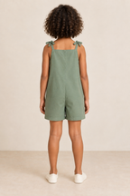 AI design preview: same child and eucalyptus romper, showing straight closed rear, shoulder bows and plain short legs without waist seam