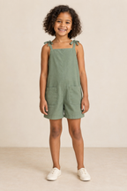 AI design preview: child in eucalyptus tie-shoulder short romper with square neckline, continuous body and two rounded patch pockets, front view