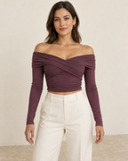 AI design preview: adult woman wearing a plum crossed-drape off-shoulder crop top with long slim sleeves and side ruching