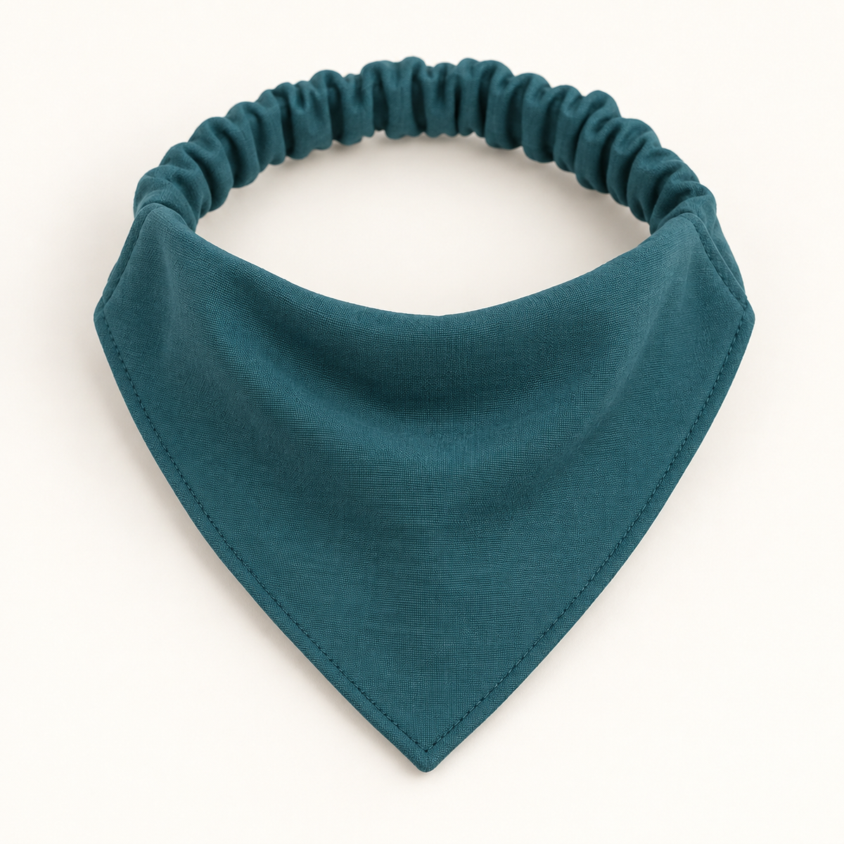 AI design preview: petrol-teal triangular dog bandana joined to a gathered elastic back casing in one continuous neck loop