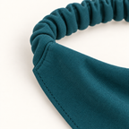 AI design preview: close-up of the petrol-teal dog bandana upper corner where the gathered casing joins the doubled bib