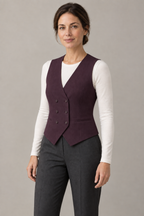 AI design preview: angled front of the same plum six-button waistcoat on the same woman, showing the V-neck and welt pockets