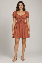 AI design preview: adult woman wearing terracotta sweetheart dress with center drawstring gathers, raised curved waist and short puff sleeves, front view