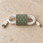 Design preview: continuous patterned back band of the cord wrap, with the cable passing through its open sides.