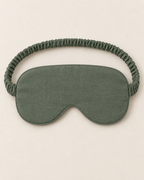 Design preview: plain sage green sleep-mask reverse and its continuous fabric-covered elastic strap, with the central nose notch visible
