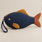 Navy fish-shaped zipper pouch with terracotta tail, ochre fins and removable wrist loop, front view