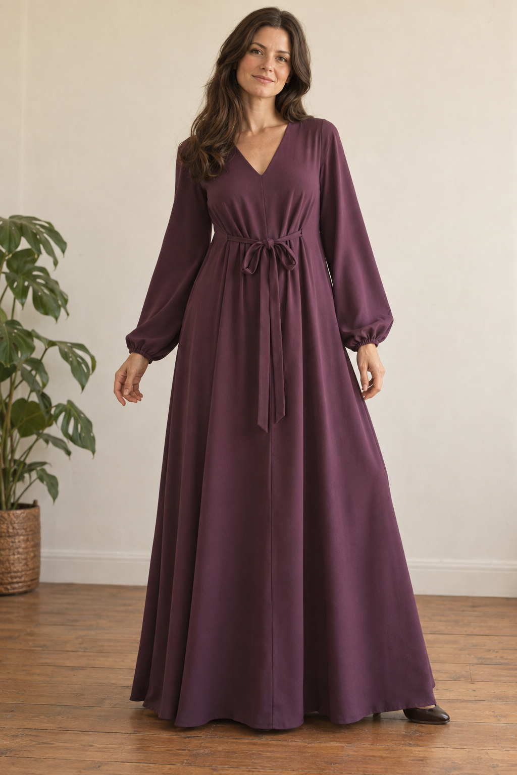 Adult woman wearing a mulberry front-tie tent lounge-gown design with long sleeves and floor-length hem