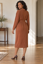 Rear of cinnamon dress showing stitched back pleats, dropped shoulders and plain tapered sleeves