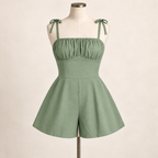 AI design preview: sage green version of the same gathered-bust romper with fitted midriff, shoulder bows and flared shorts