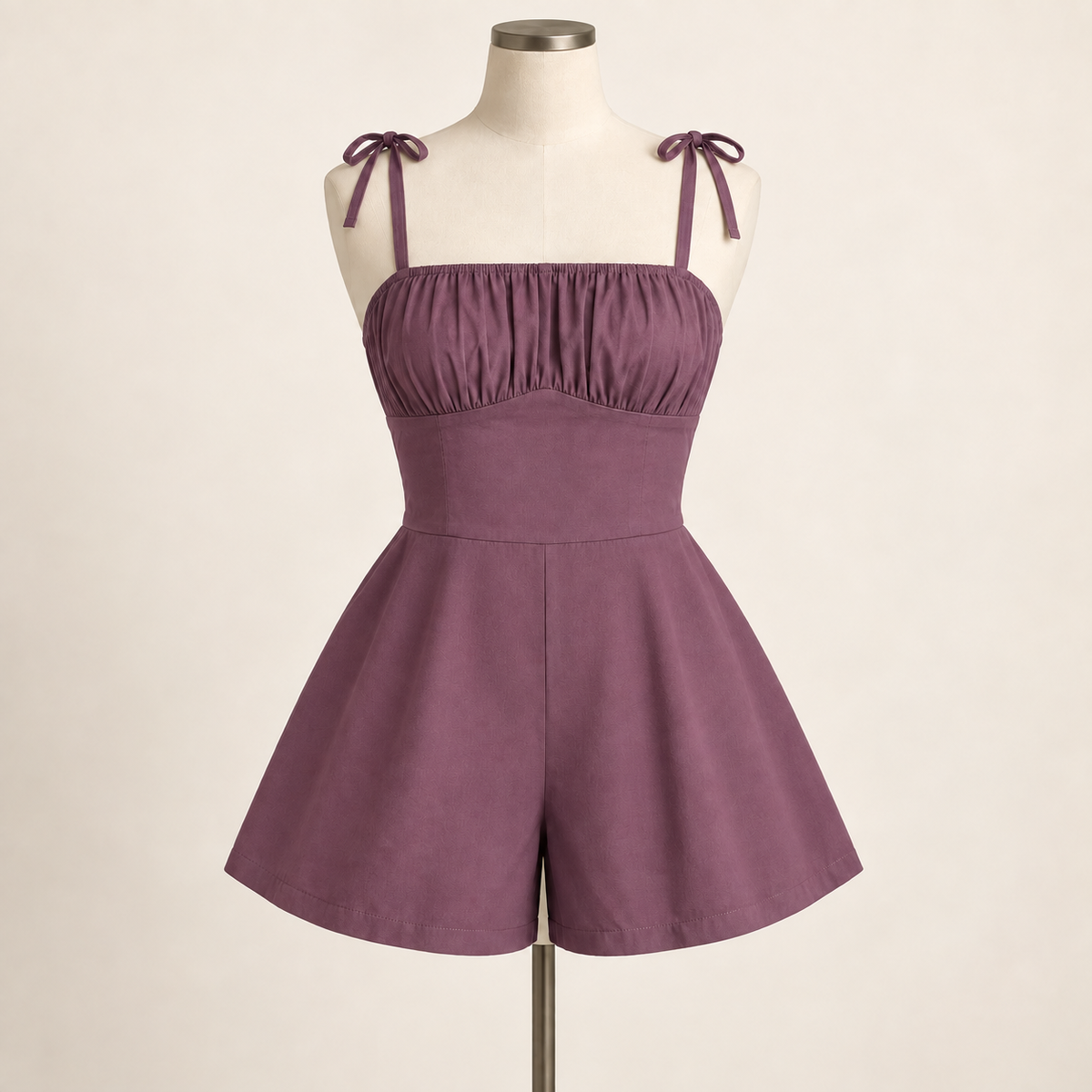 AI design preview: dusty-plum romper with gathered front bust, smooth fitted midriff, shoulder ties and two wide flared short legs