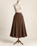 AI concept illustration of 1930s gored flared skirt, front view in alternative warm cocoa brown, on a mannequin.