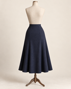 AI concept illustration of 1930s gored flared skirt, back view in ink navy, on a mannequin.